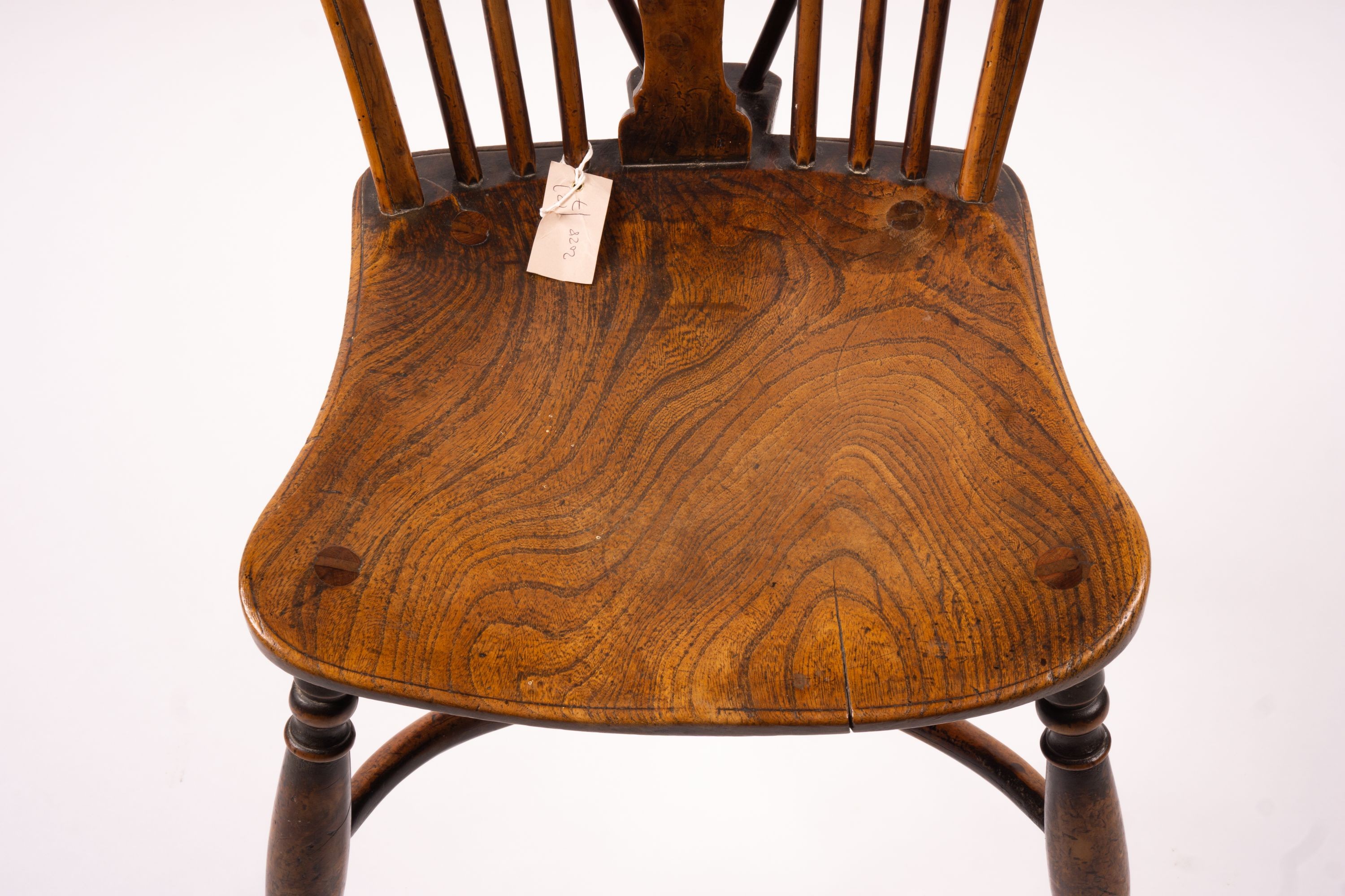 A mid 19th century ash and elm Derbyshire area Windsor elbow chair, together with a 19th century yew and elm Windsor wheel back chair with crinoline stretcher